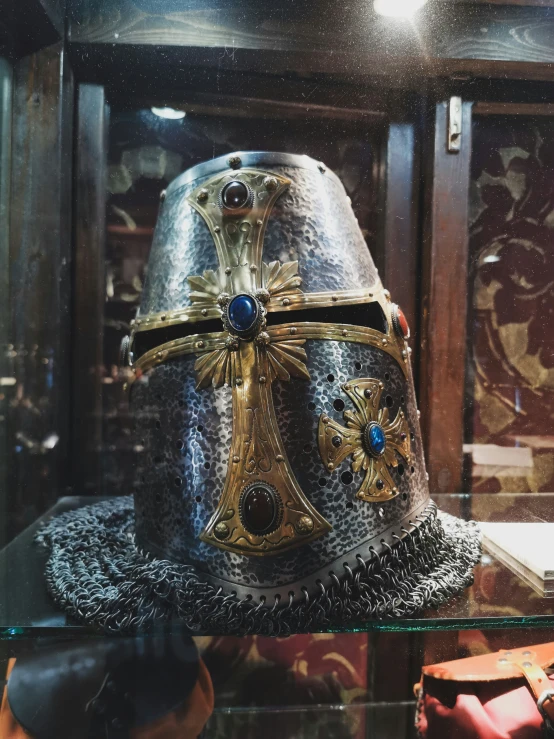 a helmet sitting inside of a glass display case