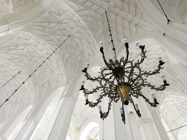 a fancy chandelier hanging from the ceiling in a building