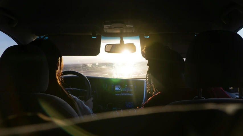 view through the back windshield of a vehicle looking out at the ocean