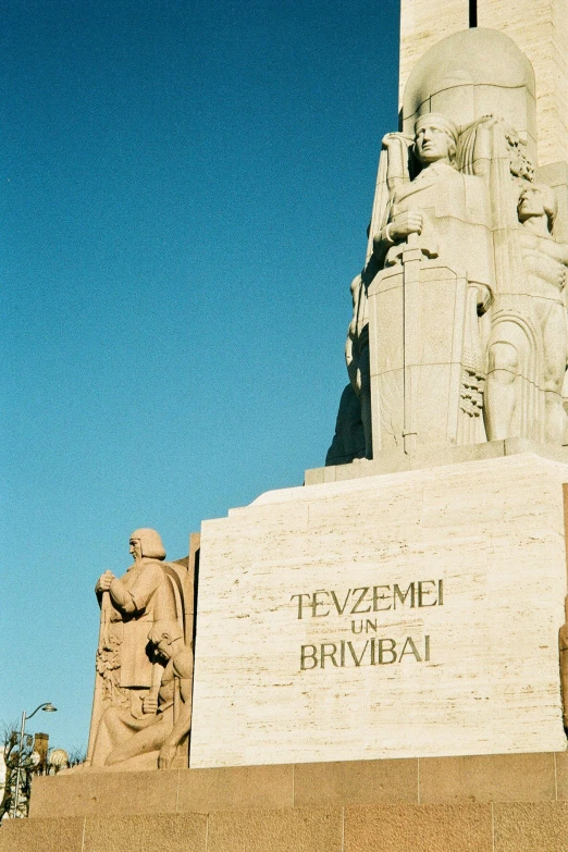 a white statue is sitting near a very tall building