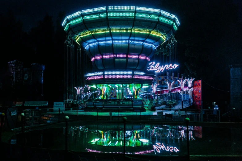 a carousel on display with some lights on it at night