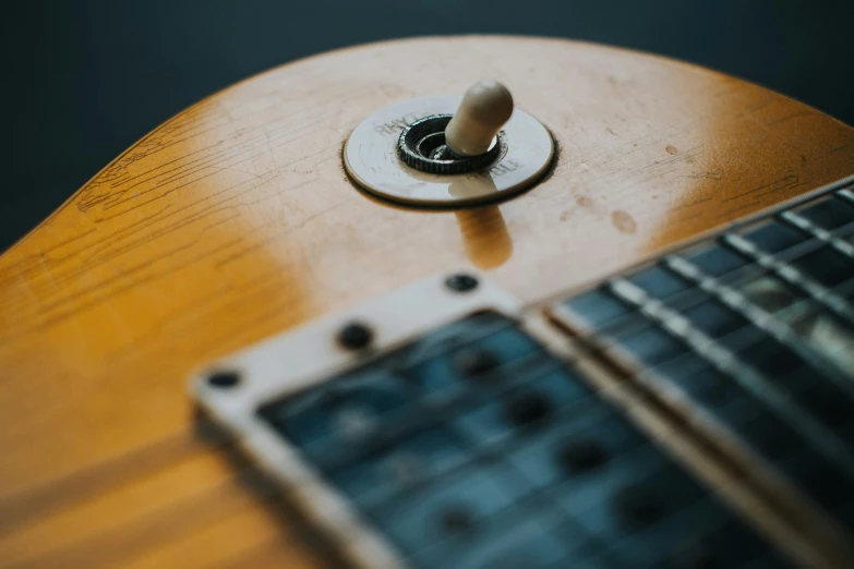 a close up of the frets on an acoustic guitar