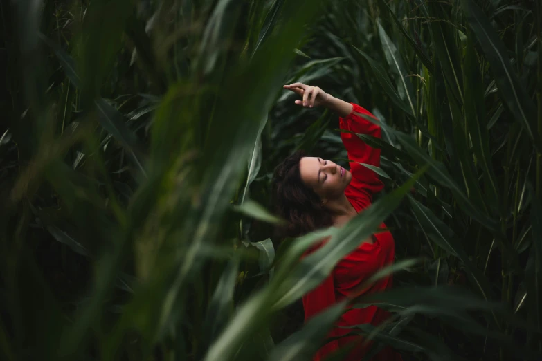 a woman is in the middle of tall green grass