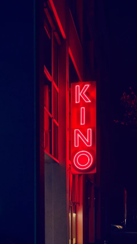 a neon sign that says no to smoking and a building that has a light up on the side