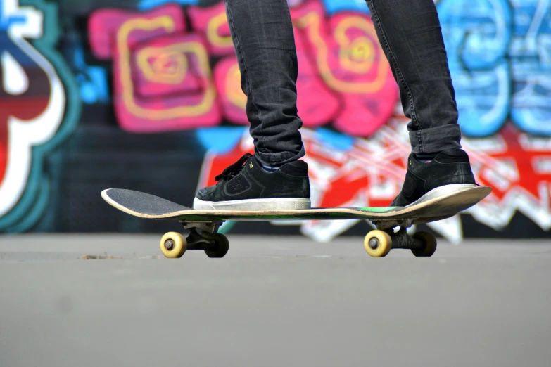 a person riding on a skateboard down a street