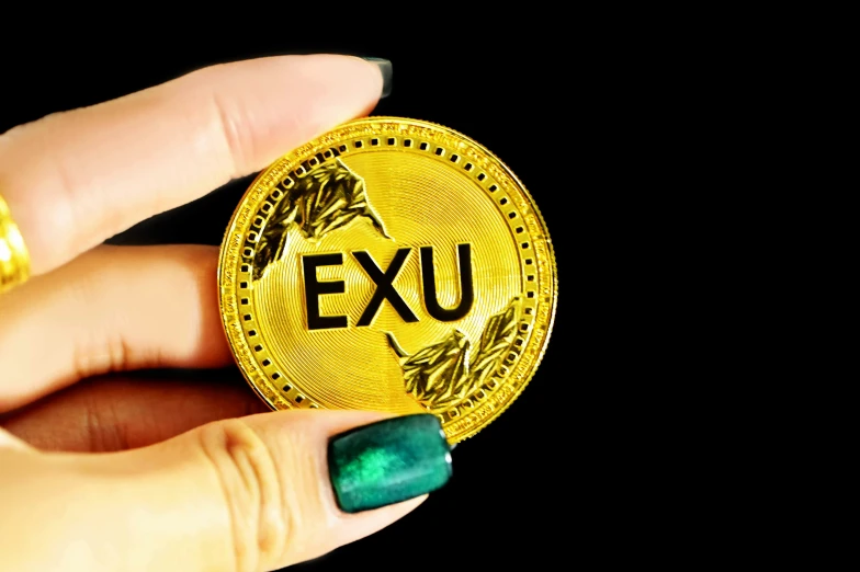 a person holding a gold coin with the word exit