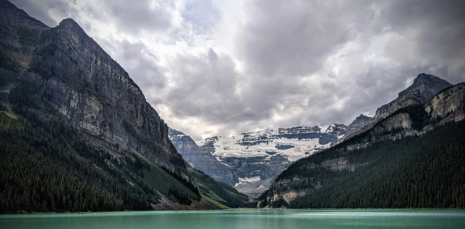 a couple of mountains standing on top of a large lake