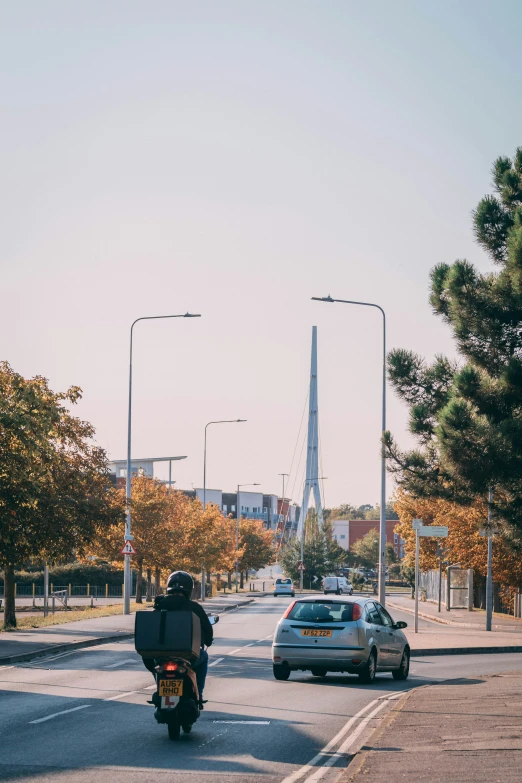 a man on a motor bike driving down the road