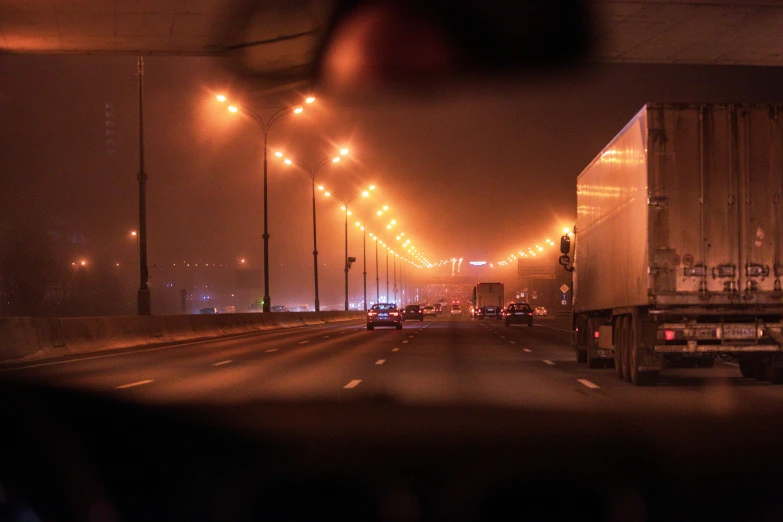 a foggy highway at night with lots of traffic