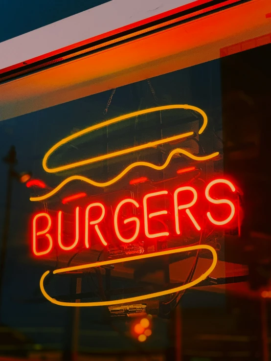 the reflection of a restaurant sign in a window