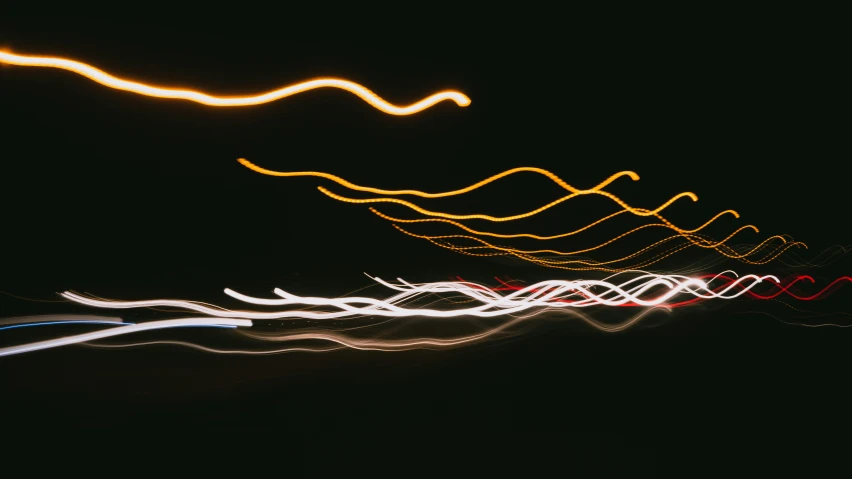 long - exposure pograph of traffic and speed on freeway