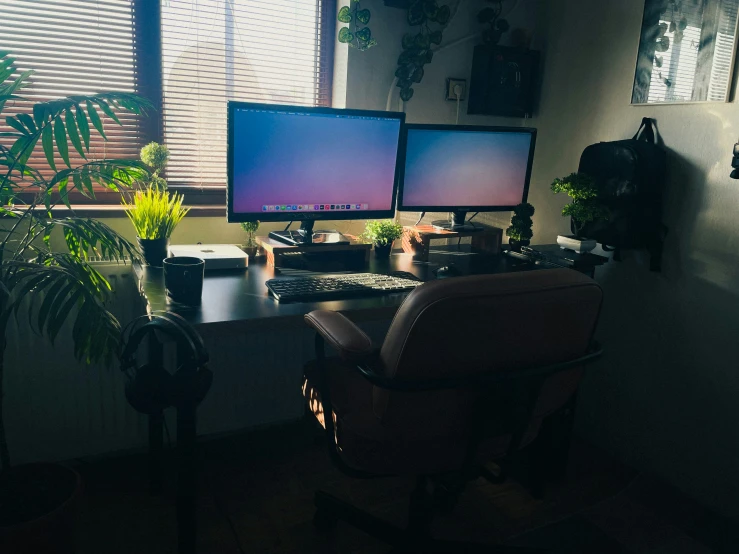 a room with a chair and two monitors on it