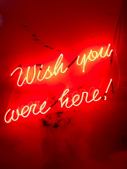 a neon sign with words in it that says wish you were here
