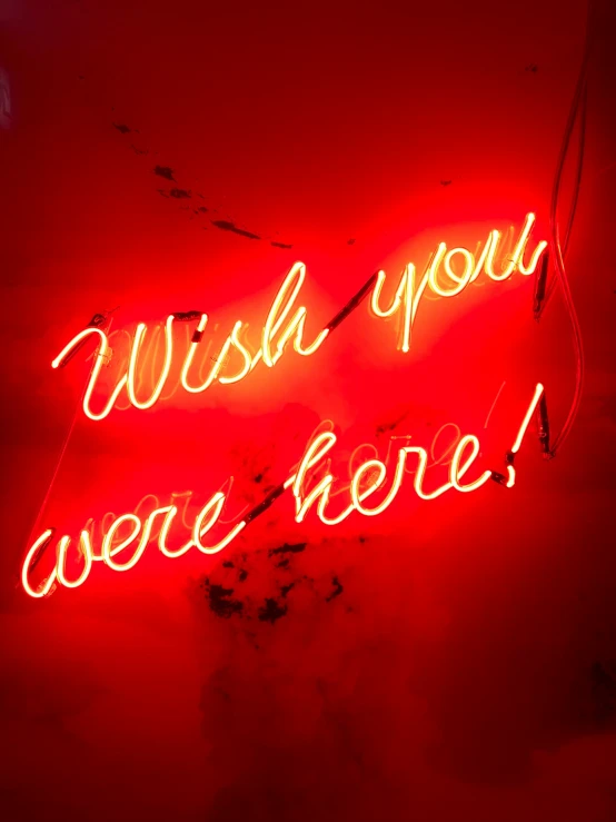 a neon sign with words in it that says wish you were here