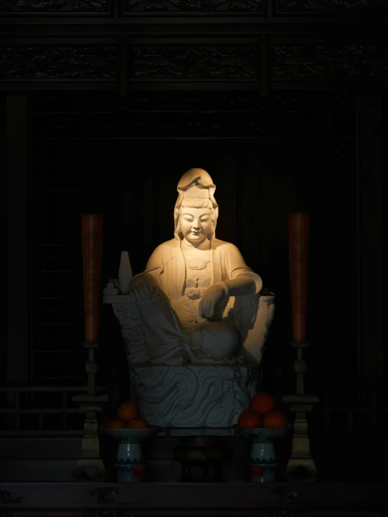 an buddha statue is lit up for people to see