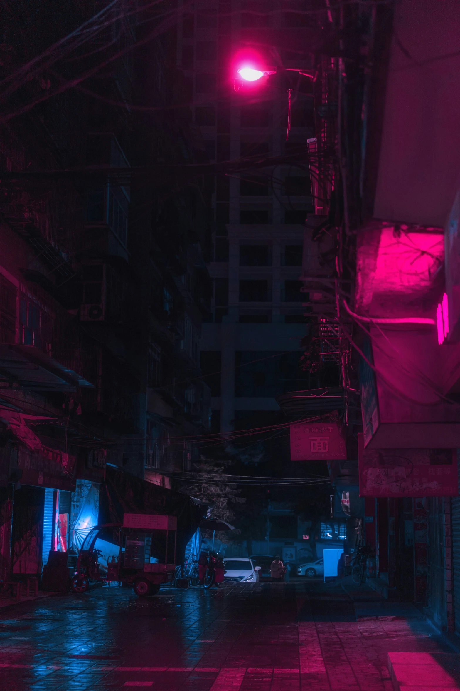 a street at night is covered in rain