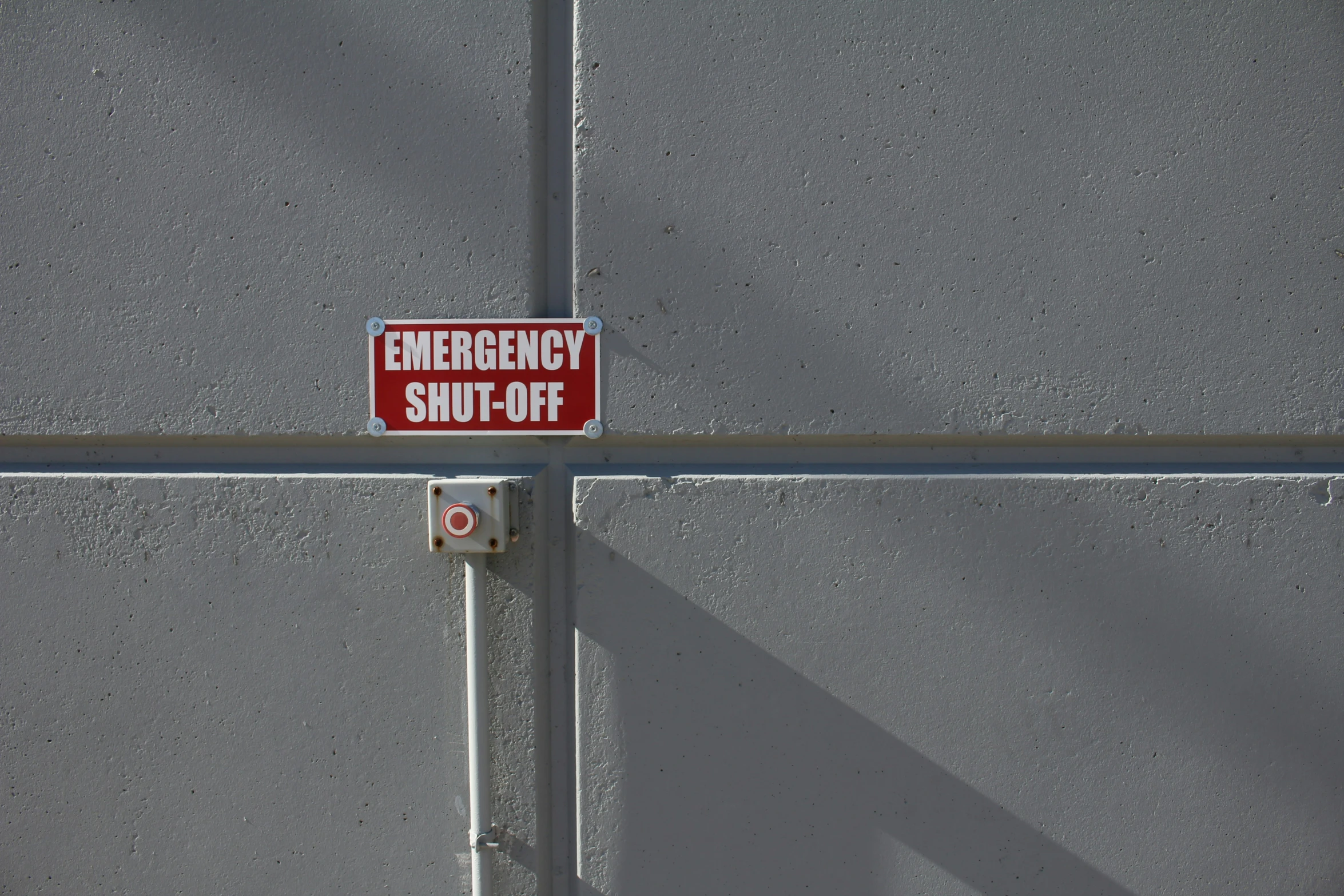 a red and white sign that is attached to a pole