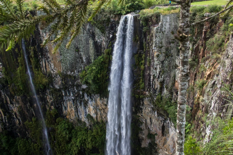 a group of people standing under a waterfall