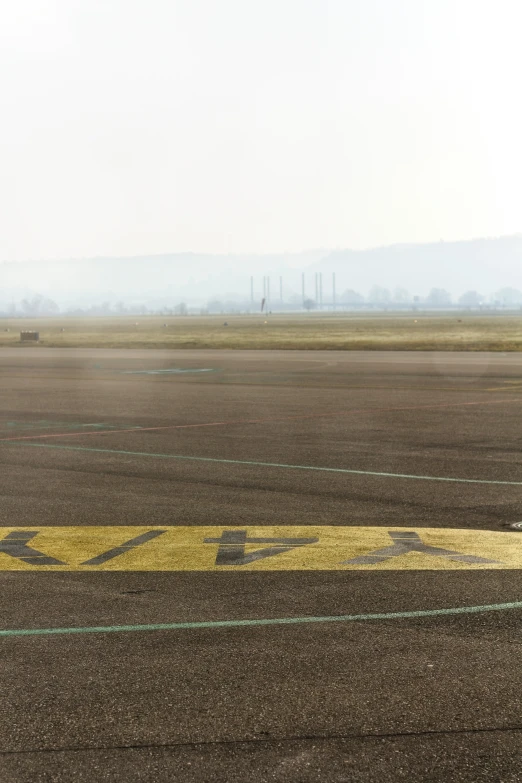 airplane landing strip on open brown grass with sky in the background