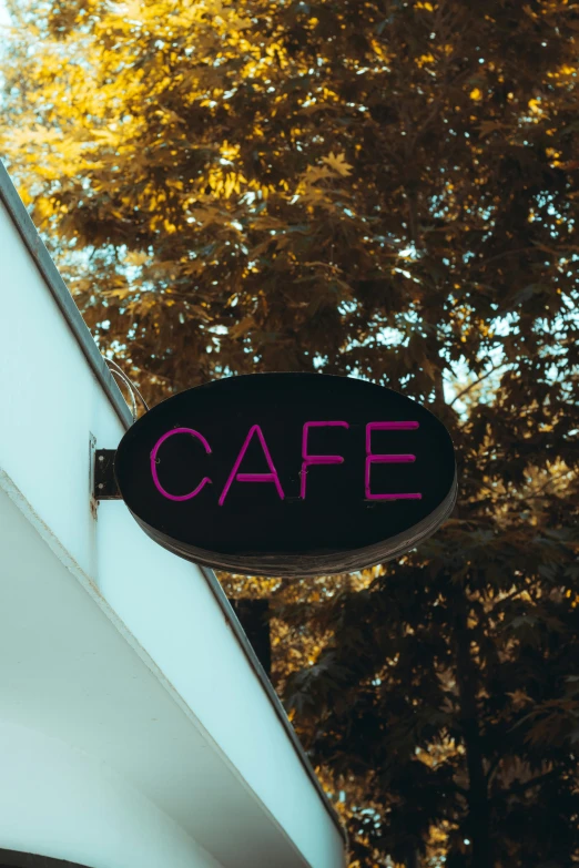 sign displaying the word cafe hanging outside on a building