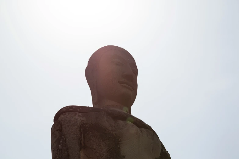 a very large statue that has a sky in the background