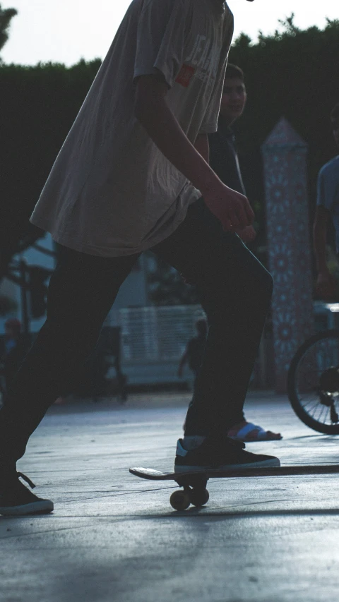 a skateboarder on his board and one on the ground