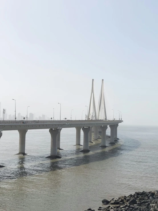 a large bridge over water with boats in it