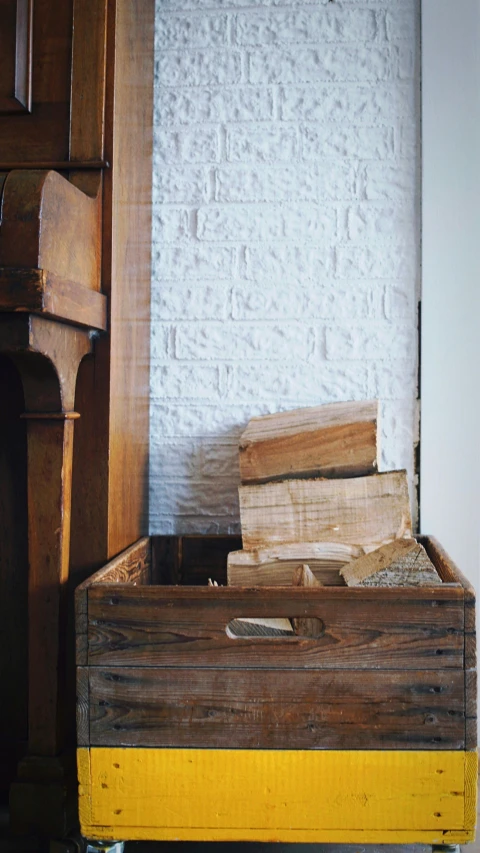 a room with a brown wooden chest of logs