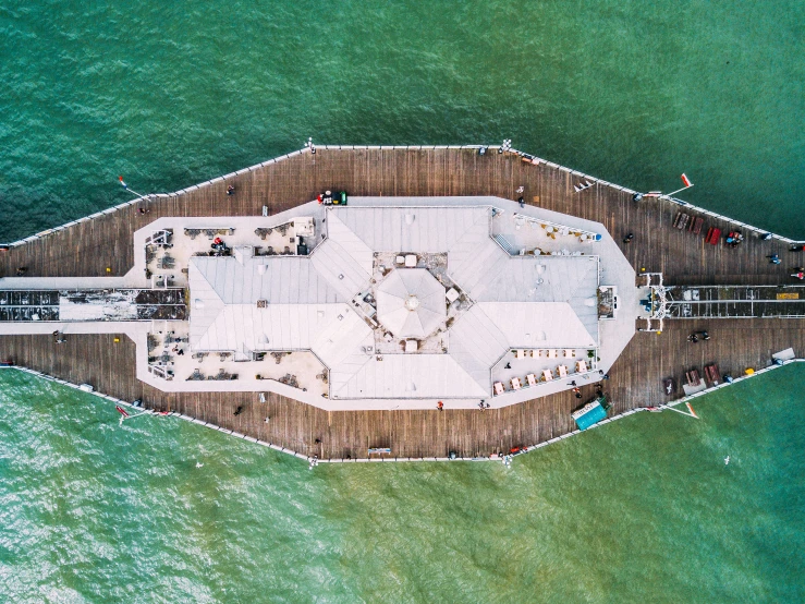 a white building in the middle of green water