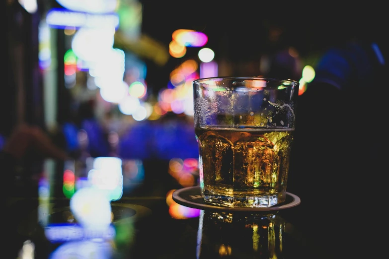 a cup of beer is sitting on a table