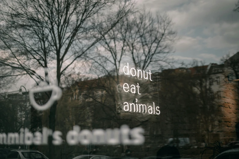 a window with the words donut eat animals written on it