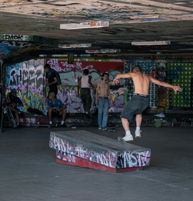 a man is performing on a skateboard in the room