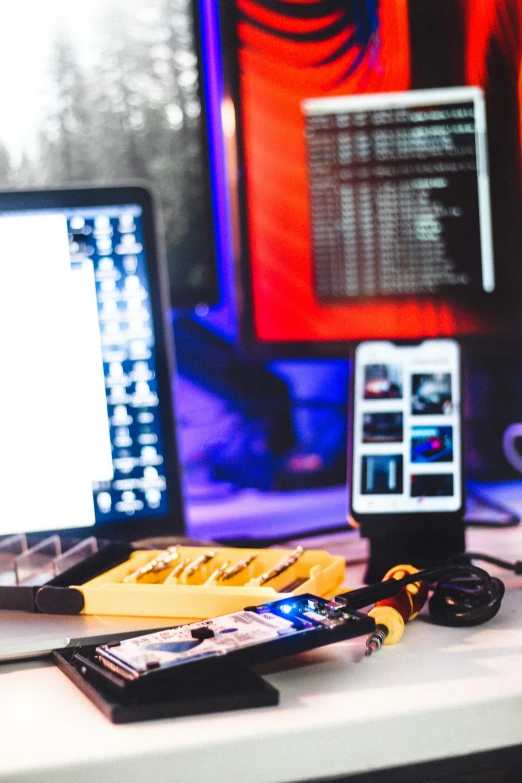 a cell phone sitting on top of a computer desk