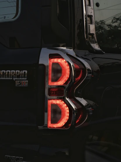 the back light of a black ford f - 150 truck