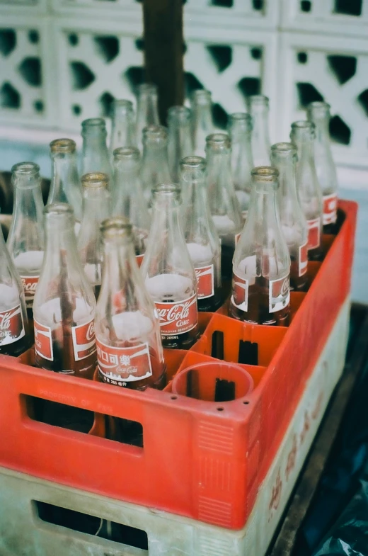 a crate filled with bottles of beer in the middle of the day