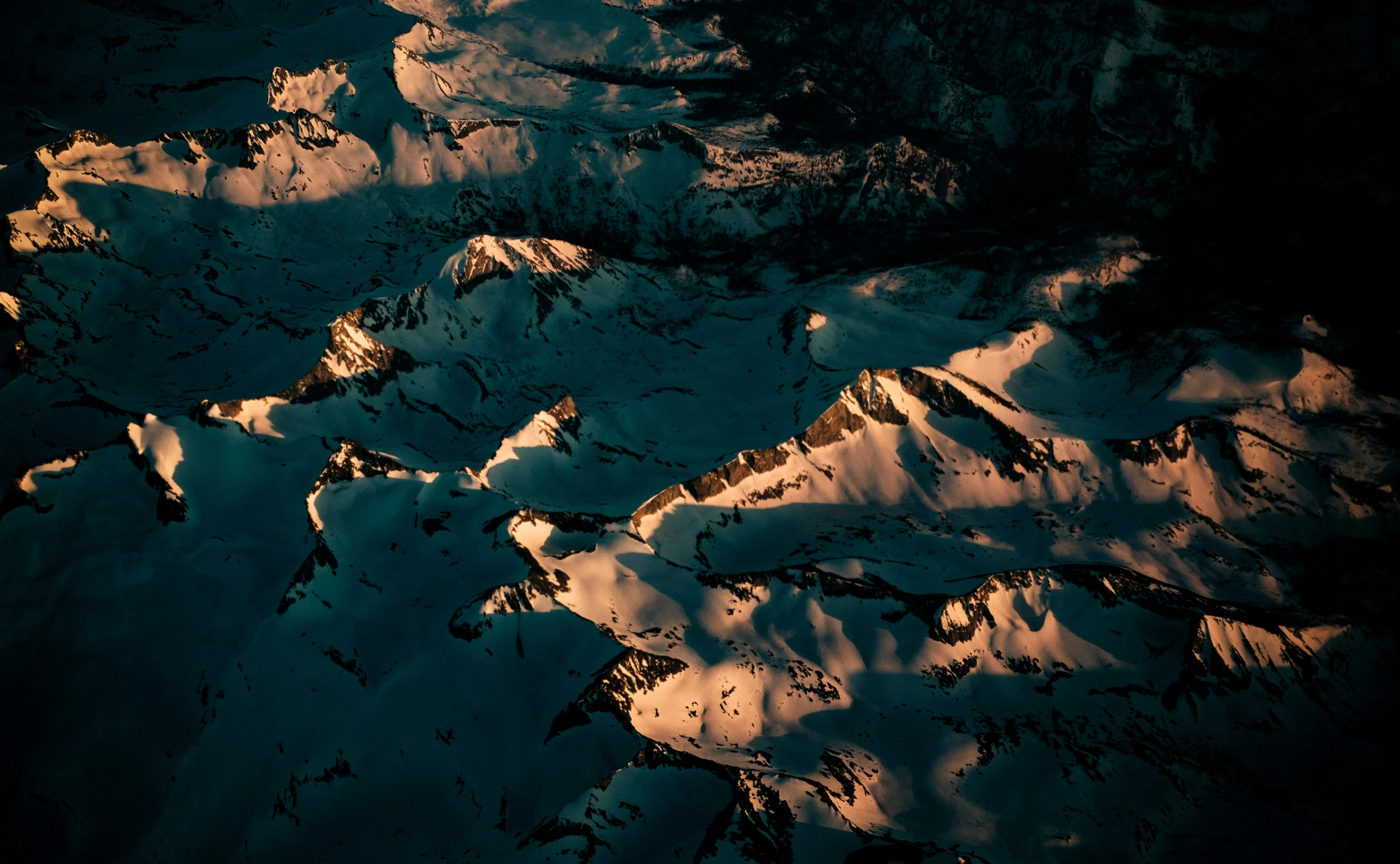 the sky and snow with a small amount of mountains in the background