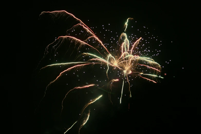 some lights and sparklers in the dark sky