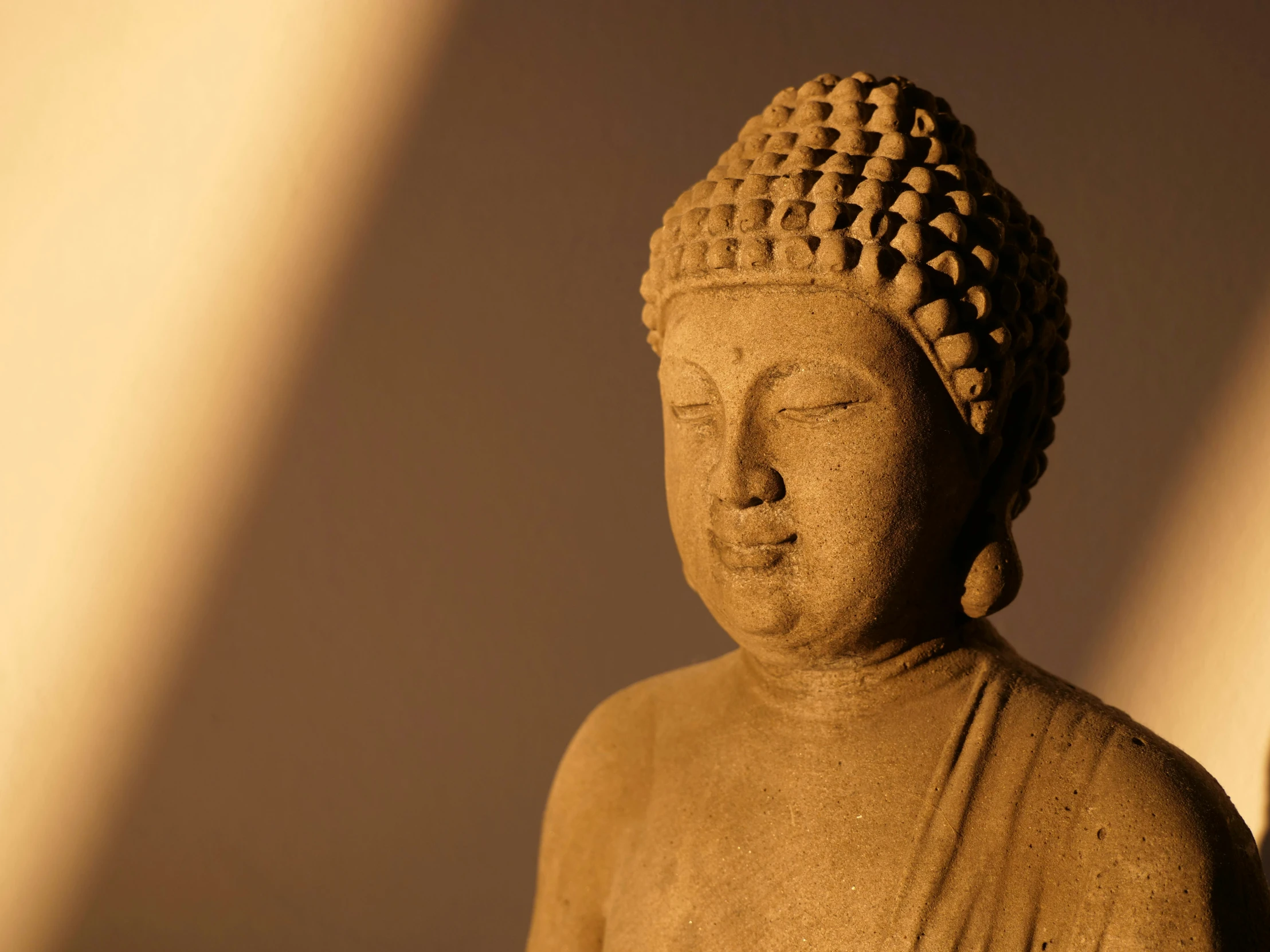 buddha statue looking up to the sky with white light shining