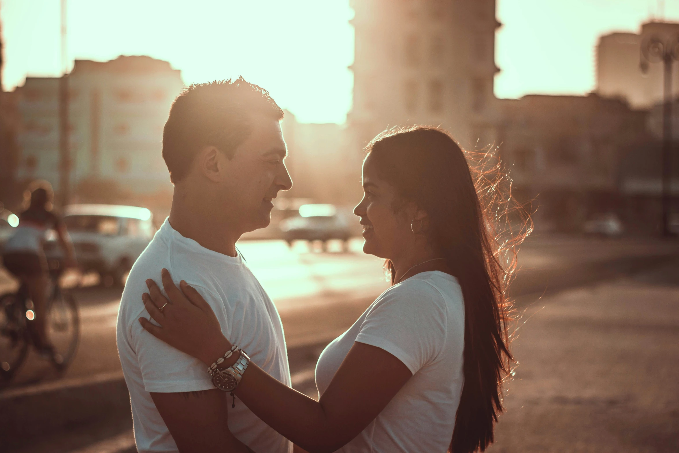 a man and woman standing on the side of a street next to a building