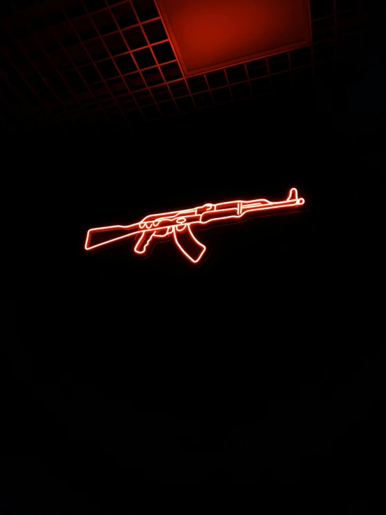 an illuminated neon rifle sign in the dark