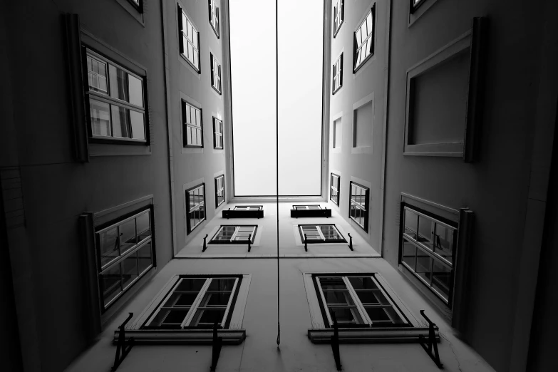 an abstract view of many windows and frames in an alley