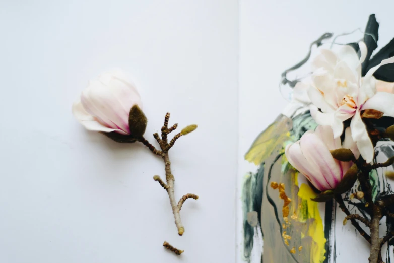 two white flowers are laying on the edge of a wall