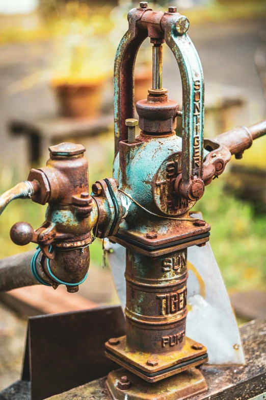 an old rusted machine with some water on it