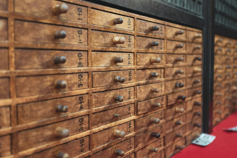 two rows of wooden file cabinets on red floor