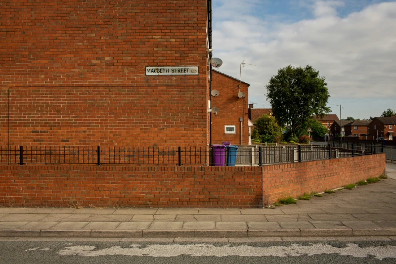 a red brick building with a fence around it