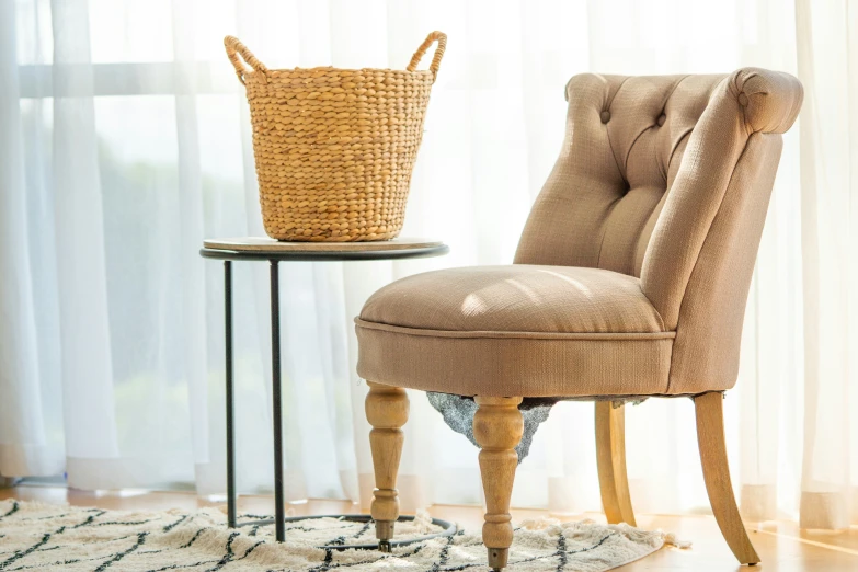a chair with a basket on top and side table