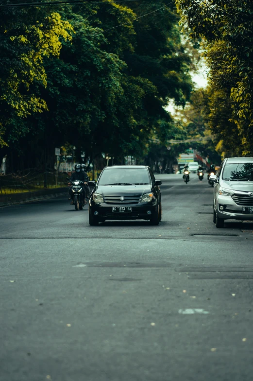 a couple of cars are going down a road