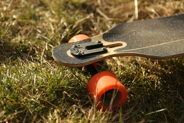 the skateboard is laying upside down in the grass