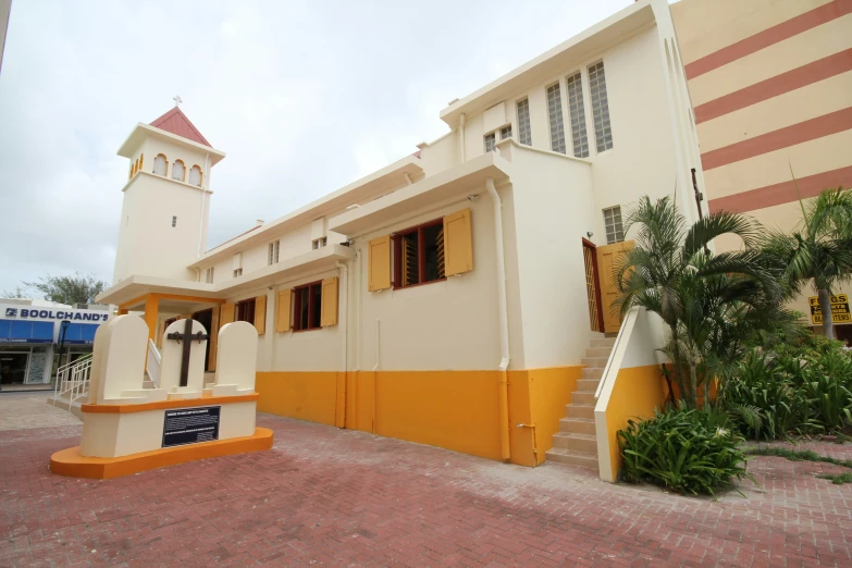 a small house with a steeple and balcony