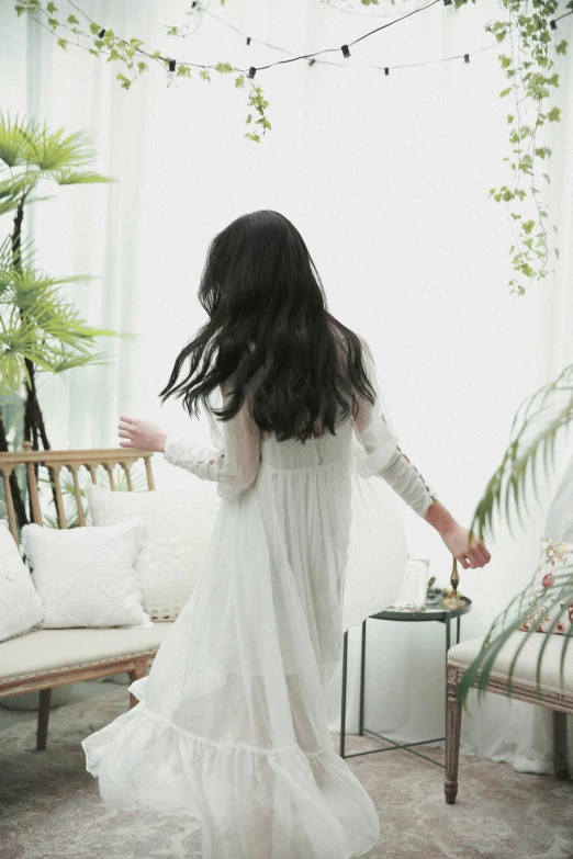 the back view of a woman in white dress
